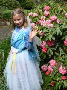 Samaira Simmons waves as she strolls through the rhododendrons of Meerkerk Gardens last  weekend. Below