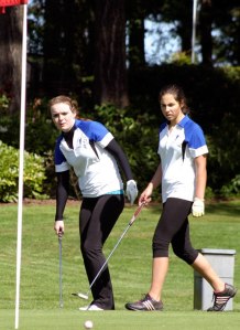 Jenna Kaik tracks her long putt on the third hole at Useless Bay Golf & Country Club during a girls golf match with Sultan. Behind her is sophomore teammate Rosie Portillo. They finished tied for third place April 29.