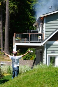 Tim Storey reacts to seeing his house on fire Monday.