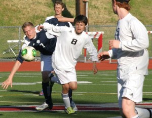 Falcon sophomore Davin Kesler fights off Cascade Christian junior forward Hunter Austin in the 1A tri-district playoff match Tuesday. Kesler