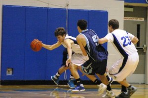 Taylor Simmons scrambles to dribble a loose ball against Turk junior forward Steven Branham as Falcon sophomore Nick French sets a back screen.