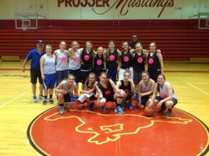 South Whidbey High School basketball players take a break during a practice at Prosser High School where their head coach Andy Davis played as a teenager.