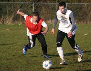 Junior Cameron Coupe battles Darby Hayes for the ball during a recent Falcon boys soccer practice.