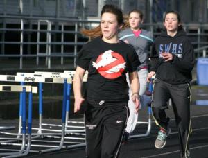 Bailey Auburn leads fellow Falcon sprinters Sarah Cepowski and Sylvie Kaul-Anderson through warmups.