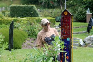 Freeland-based glass artist Dale Reiger ensures one of his recognizable glass house pieces is spick and span before the 2016 Froggwell Biennale.