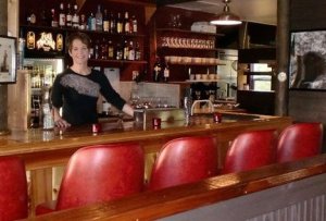 Kate Buzard stands behind the bar that she built at 19o4 Public House