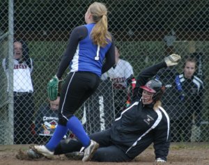 Falcon junior pitcher Alex Kubeska runs to cover home plate on a passed ball against Cedarcrest as Karly Gidlof slides home to score the go-ahead run in the seventh inning.