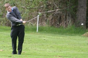 Jerimiah Robey chips from the fourth fairway Thursday.
