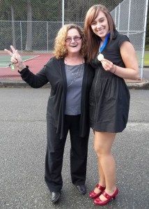 South Whidbey High School teacher and DECA leader Sharyl Harless congratulates DECA state competition winner Amber Gilkerson