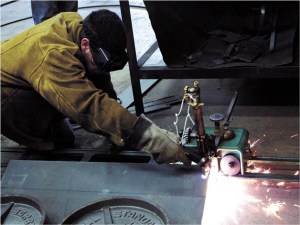 Cameron Clark cuts through a steel plate to shape a piece of the Admiralty Head Lighthouse during last semester’s Advanced Metal Fabrication class. South Whidbey has built a third of the lantern for the lighthouse at Fort Casey.