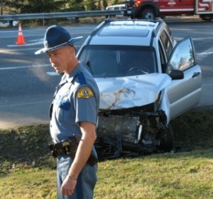 Trooper Norm Larsen gathers information after a KIA sport  utility vehicle and Ford pickup truck collided at the  intersection of Cultus Bay Road and Highway 525 Sunday afternoon.