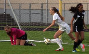 Falcon junior Samantha Baldwin sprints out of the Red Wolves’ goal after scoring in the 11th minute on a cross by junior Olivia Bolding on Tuesday. South Whidbey’s early lead didn’t hold in the 3-2 loss.