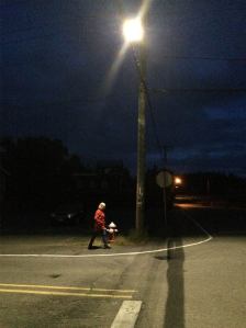 Joann Quintana walks underneath one of Langley's LED test bulbs on Third Street and Park Avenue.