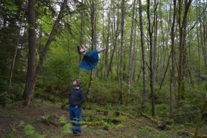 Eli Moore looks on as his wife and fellow bandmate Ashley Eriksson swings in their backyard. Moore and Eriksson will perform with their band