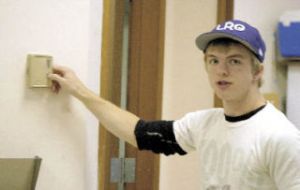 South Whidbey High School senior Chase Brown checks out an old thermostat in a high school classroom. Brown conducted an energy audit this spring that could potentially save money for the school district over the next few years.