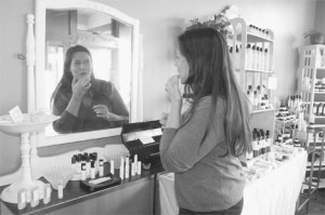 Karen Wilson tries out some of Sweet Sisters lip balm at the shop at the Bayview Cash Store.