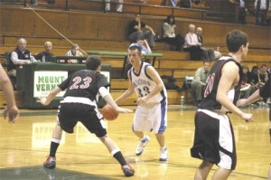 Falcon Blake Blakey tries to avoid Wildcat defender Jared Smith during South Whidbeys final basketball game of the year at Mount Vernon High School on Tuesday.