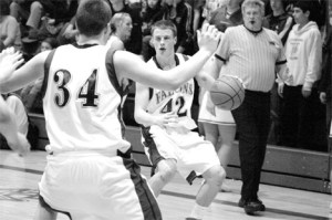 Falcon Eric Stallman looks to Parker Barnett in the third quarter before throwing to CJ Baker on the inside. Baker scored two and the team went on to win