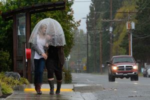 Mother and daughter Ada Rose Faith-Feyma and Sheila Weidendorf of Langley walk down Main Street in Freeland Friday for a cup of joe at WiFire Cafe. Others on South Whidbey were busy preparing for the coming storm, buying batteries and other emergency supplies.