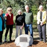 Evan Thompson / The Record South Whidbey community members recently gathered to celebrate the installation of a plaque and boulder that commemorates the six-year effort of a group that prevented Saratoga Woods from being developed into a 200-room resort. From left to right: Sharon Emerson, Cynthia Tilkin, Diane Kendy, Kim Drury, Charlie Snelling, Betty Azar and Larry Harris.