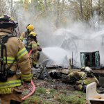 Kyle Jensen / The Record South Whidbey Fire/EMS firefighter Travis Zimmerman looks on as responders put out the trailer fire.