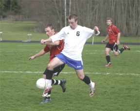 Falcon power forward Henry Mead pushes past a Coupeville Wolf opponent during the soccer team’s 3-2 win at Waterman Field on  Tuesday.
