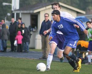 Falcon sophomore forward James Young turns past a Wolverine defender during Thursday night’s game.