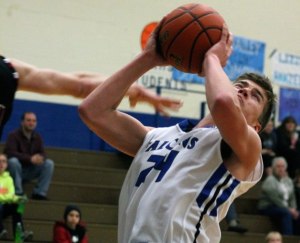 Falcon senior CJ Sutfin rises to the hoop for a layup attempt as he’s fouled by a player on the Cedarcrest Red Wolves on Friday