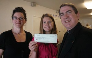 Annee Imle (center) of Habitat for Humanity of Island County receives a $3