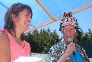 Hanson’s office manager Michelle Sterba assists Conductor of Fun Jim Freeman as he leads the activities at Hanson’s Building Supply 30th anniversary celebration Friday.