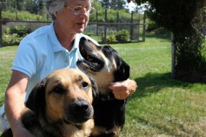 Merritt Atwood of Freeland plays with her dogs Milton (left) and Nelson. Both dogs were adopted from WAIF recently and are eligible to be in the King and Queen dog contest at Wag ’n‘ Walk this year