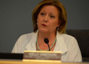 Island County Commissioner Kelly Emerson reads from a statement announcing a settlement in her long battle with Island County Planning and Community Development.