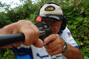 Mike Gallion practices with his High Standard .22-caliber pistol in his private range behind his Freeland home. Gallion has bad vision but is an accomplished steel challenge competition shooter.