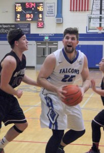 Falcon senior Mo Hamsa eyes the rim for a layup against Cedarcrest senior Adam Davenport on Feb. 3.