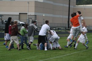 Fans and players rush Pat Myatt to celebrate South Whidbey’s 3-2 triple-overtime win against Sultan. The win sends South Whidbey to the District 1 tournament
