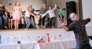 Musical Director Matt Bell shows enthusiasm in leading his troops stationed on the stage behind him.