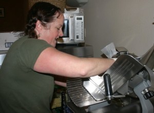 Kim Bailey slices cheese at 10 a.m. Monday to prepare for what was already a busy “Customer Appreciation Day.” The owner of Pickles Deli was thankful after customers voted her sandwich shop as King 5’s Best of Western Washington.