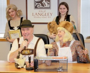 Actors portraying Hasenpfeffer Incorporated entrepreneurs pitch their need for local rabbits for a faux restaurant specializing in rabbit stew.