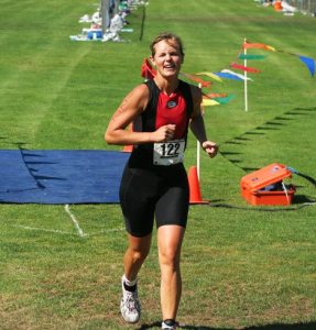 Triathlete Kristi Eager prepares to run up the hill and into the woods at Community Park for the 3.2-mile portion of the Whidbey Island Triathlon.