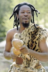 Tonderai Phiri smiles as he plays during an impromptu jam session in Langley with the group Mawungira Enharira on Thursday. The six-man group is on South Whidbey this weekend as they kick off a U.S. tour that runs through July. At right