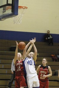 Falcon Lindsey Newman fights for the ball under the net against Coupevilles Sarah Vass during Fridays 60-26 win over the Wolves for their second league victory.  Newman led scoring for South Whidbey with 27 points and 15 rebounds. The team begins the second half of the season this week and are hoping to pull themselves out of the Cascade Conference cellar.