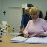 Kyle Jensen / The Record Helping Hand Executive Director Rosemary Martin checks her calendar for appointments as volunteer Kim Sorensen looks on.