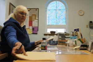 Kyle Jensen / The Record Volunteer Kim Sorensen sifts through a patient&rsquo;s file.