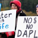 Michael B. Watkins/Whidbey News Group                                Protesters opposing the Dakota Access Pipeline stand outside Wells Fargo Bank in Coupeville Tuesday. The group opposes the bank funding the pipeline project and the potential impact to the environment.