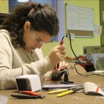 Evan Thompson / The Record                                Eighth-grader Sophia Paczynski uses a soldering iron to attach wires to a dismantled auto back-up camera&rsquo;s circuit board. The white box on left is for making a mold to create the camera&rsquo;s waterproof casing.