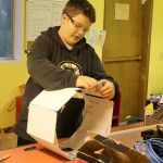 Evan Thompson / The Record                                Eighth-grader Sophia Paczynski uses a soldering iron to attach wires to a dismantled auto back-up camera&rsquo;s circuit board. The white box on left is for making a mold to create the camera&rsquo;s waterproof casing.