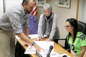 Evan Thompson / The Record                                Damon Arndt shows schematics of his proposed wellness centre to Rene Neff (center) and Ursula Shoudy (right) of the Langley City Council.