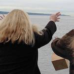 Contributed photo Members of Hunziker&rsquo;s family toss a biodegradable box containing Hunziker&rsquo;s ashes off a ferry on the Mukilteo-to-Clinton route.