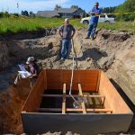 Dawn M. Chapel, a hydrogeologist with Pacific Groundwater Group, marks down drainage rates at one of several test pits in May of 2015 on a 24-acre property off Highway 525. The Freeland Water Sewer District had several tests performed prior to purchasing the land late last year for the phase 1 A sewer project. District commissioners recently learned, however, the technology it planned to utilize to disperse treated effluent back into the ground may be more expensive and less effective than initially believed, putting the property&rsquo;s viability for infiltration into question.