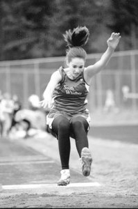 Emma Barker-Perez leaps into the sand during the long jump competition at Thursday's home track meet.
